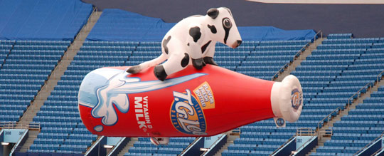 Coke a Cola and Bud Light blimps over ice rink.